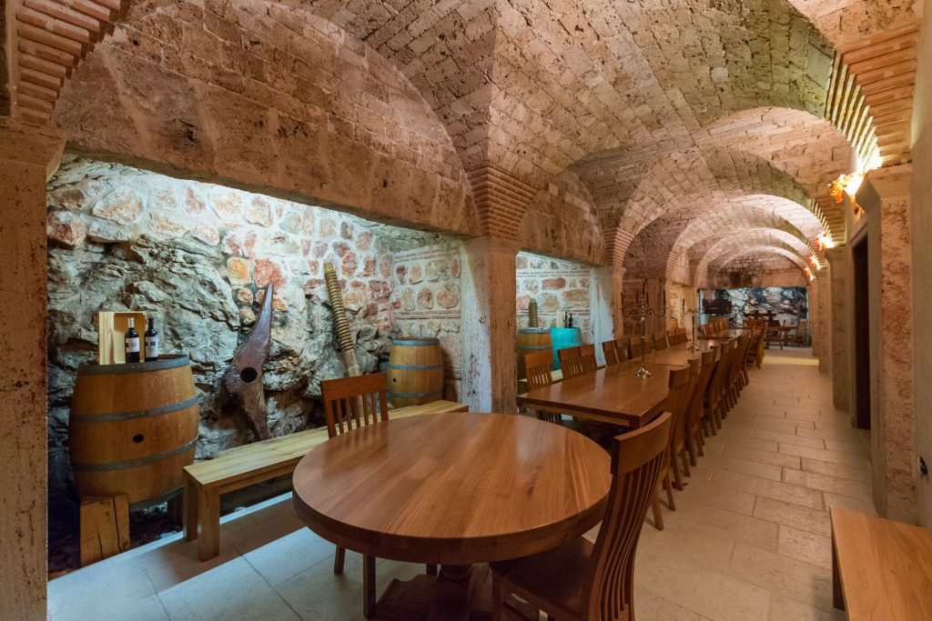Stunning wine tasting venue, buried in stone bellow the winery and modeled on the ancient Roman dining room called triclinium.